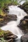 Norway. Waterfall cascades down cliff. Art Print